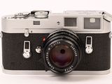a black and silver camera on a white background
