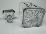 two glass salt and pepper shakers sitting on a table