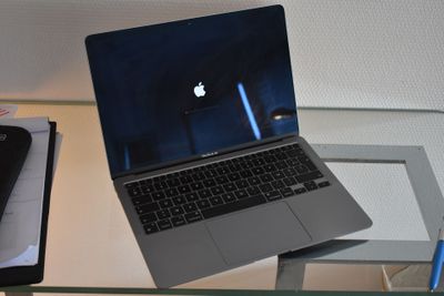 a laptop computer sitting on top of a glass table