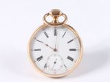 a gold pocket watch with roman numerals on the face