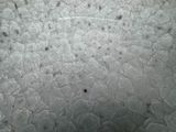 a close up of a metal plate with a lot of holes in it