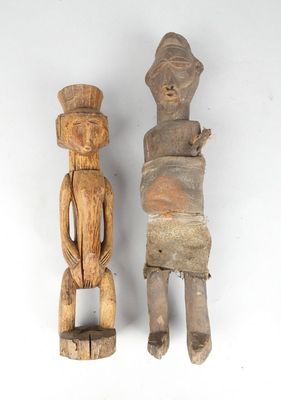 pair of carved wooden figurines of a man and a woman