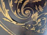 a black and gold vase with gold designs on it