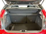 a red car with its trunk open on the floor
