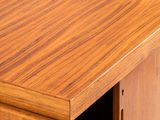 a close up of a wooden cabinet with a door open