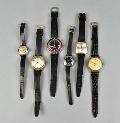 several different types of watches are lined up on a table