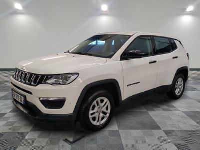a white jeep compass parked on a checkered tile floor
