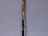 a close up of a cane with a wooden handle on a white background