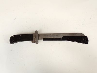 an old knife with a black handle on a white surface
