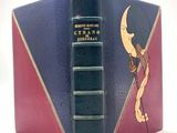an old book with a picture of a man holding a moon on it
