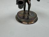 a statue of a man holding a watering can