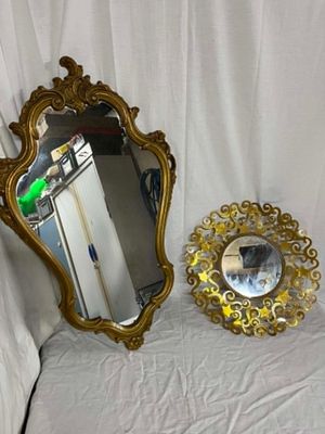 a mirror and a mirror on a bed with a white sheet