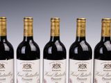 four bottles of wine are lined up on a table