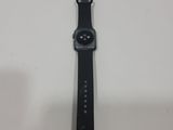 a close up of a black apple watch on a white surface
