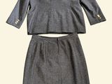 grey skirt suit with gold buttons on the sleeves