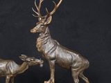 statue of a stag and a baby deer on a marble base