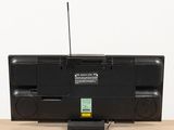 a black television sitting on a table with a radio on top of it