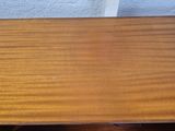 a wooden table with a drawer on top of it