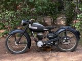 a black motorcycle that is parked on the side of the road