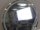 a mirror that is sitting on a table in a room