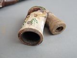 a small pipe that is sitting on a table next to a cane