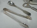 several spoons and spoon rest on a table with silverware on it