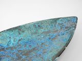 blue and black pate on a surfboard sitting on a white surface