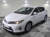 the white toyota corollant is parked in the garage