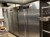 stainless steel refrigerators in a commercial kitchen with a lot of counter space