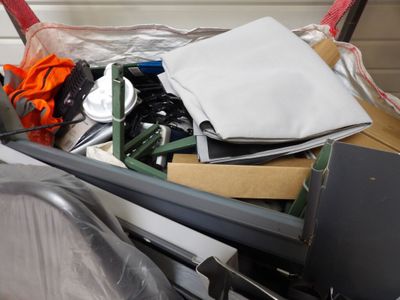 a pile of assorted items in a bin on the floor