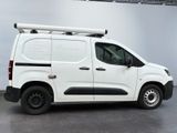 the white van is parked in the garage with its roof rack on