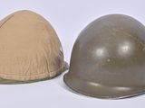 two helmets are sitting next to each other on a white surface