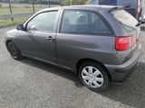 a grey car parked in a parking lot with other cars in the background
