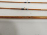 three different types of fishing rods on a white surface