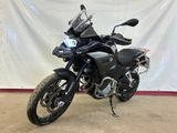 a picture of a black motorcycle parked in a garage