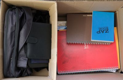 a box full of books and notebooks in it