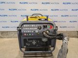 an image of a small air compressor sitting on top of a cement floor