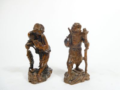 pair of carved wood figures of a man and a woman