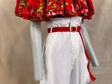 a mannequin wearing a red and white dress with flowers on it