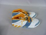 pair of white and blue sneakers with yellow laces on them
