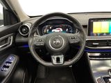 a picture of the interior of a car with a steering wheel and dashboard
