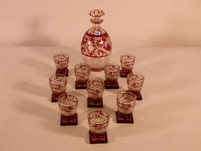bottles and cups are arranged in a circle on a white surface
