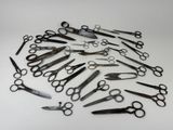 several pairs of scissors are arranged in a circle on a white surface