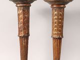 pair of wooden candlesticks with carved designs on the bases