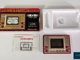 a game and watch set in a box on a table