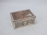 an antique silver box with a picture of a man and a woman on it