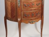 a marble top chest of drawers on a wooden stand