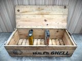 a wooden box that has two bottles of beer in it