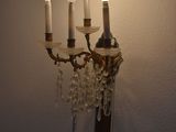 a wall mounted candle holder with five candles on it
