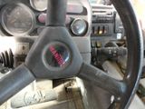 a steering wheel and gauges in a truck